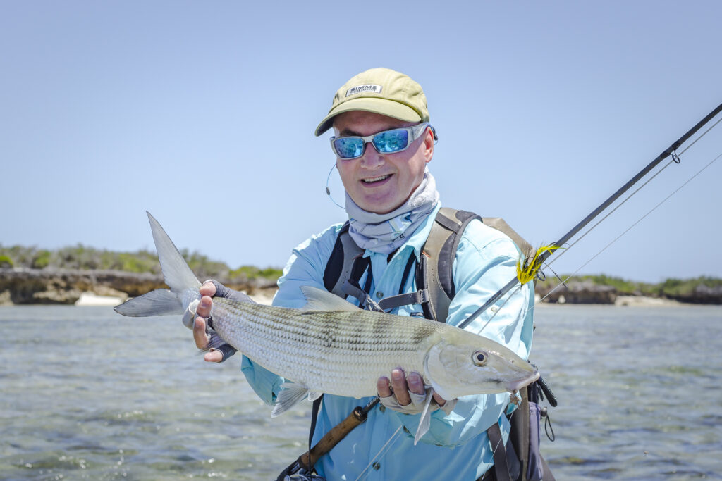 Angler with reel holding a bonefish