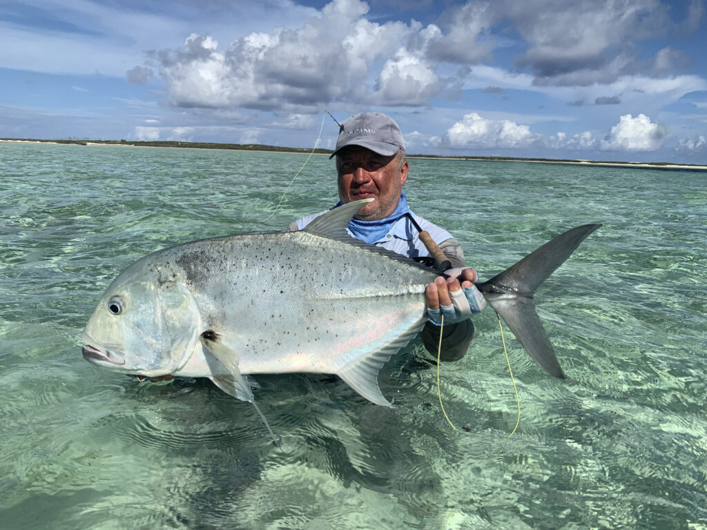 Angler holding a giant trevally