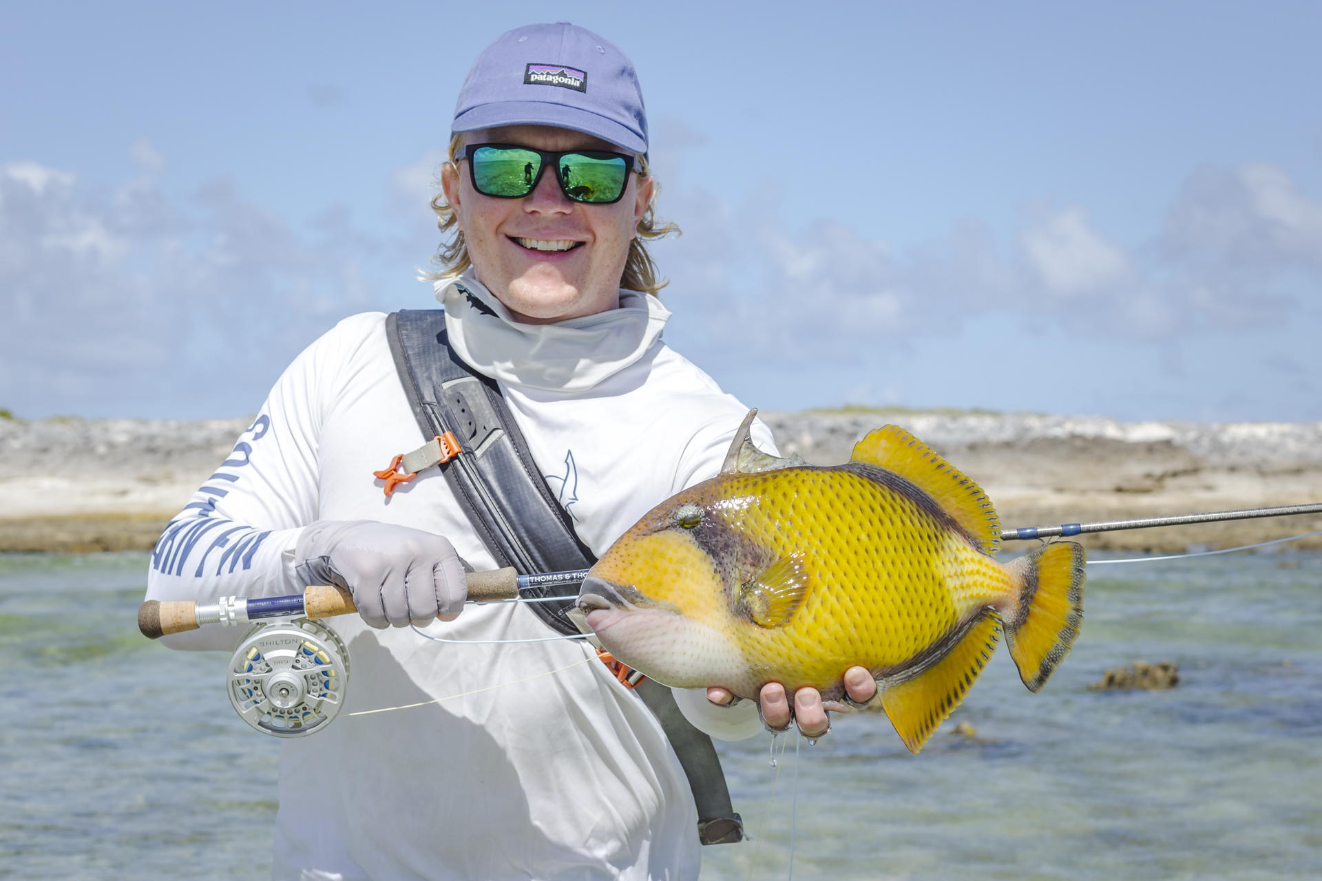 Angler holding a moustache triggerfish