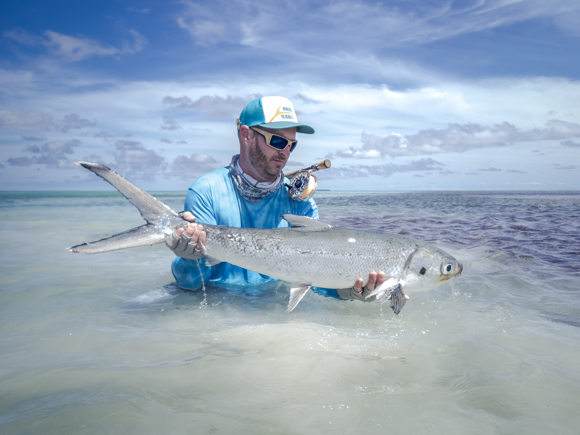 Angler with a milkfish in the Seychelles