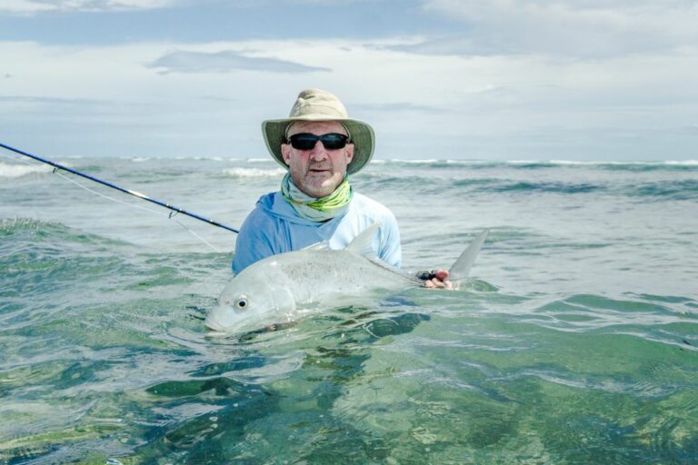 Angler with hat and reel with his catch during Exciting Spring Tides