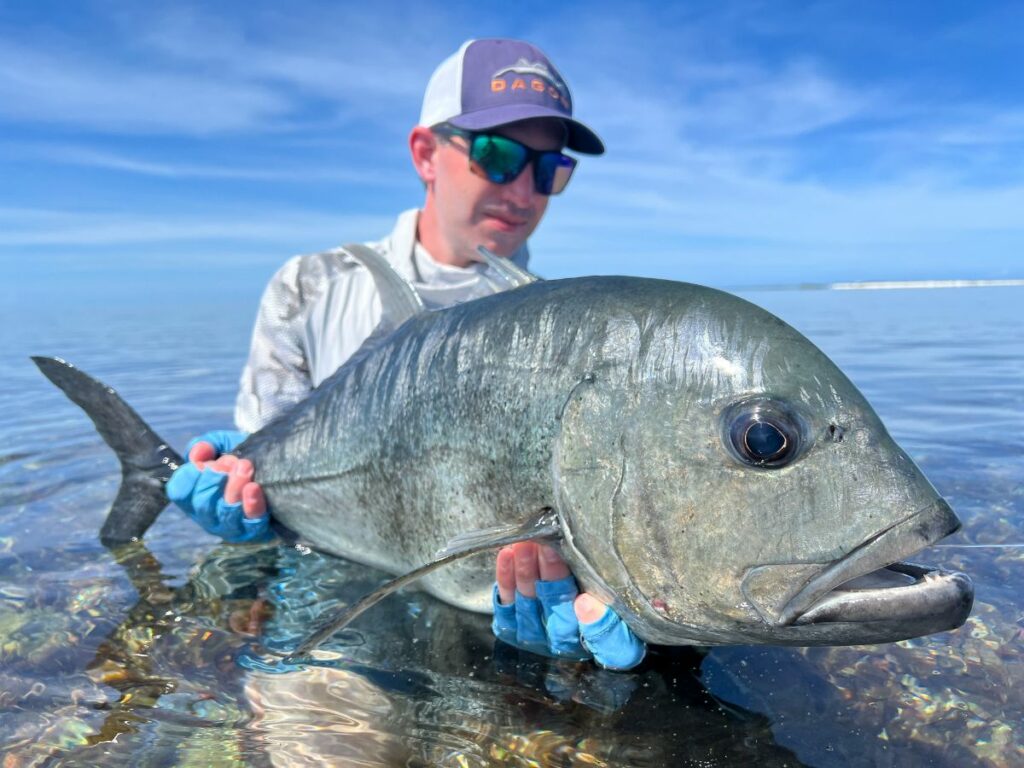 Angler landed his catch in moving water