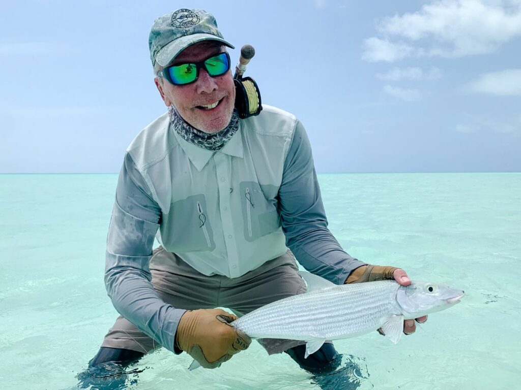 Great catch at Cosmoledo with fisherman landing a fish - a bruiser of a catch