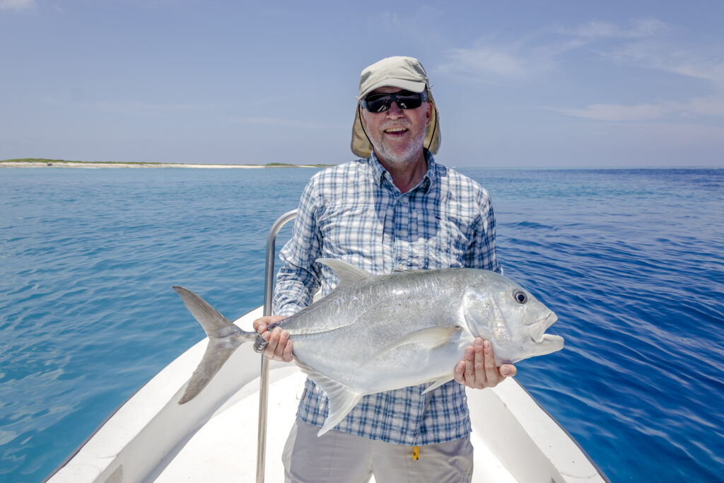 Angler with his GT catch at Astove Atoll