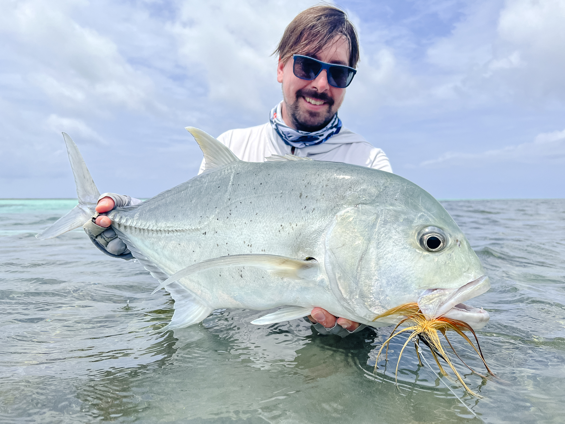 Angler with a GT caught on fly at Cosmoledo Atoll