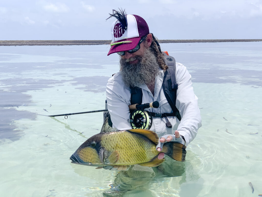 Angler at Cosmoledo Atoll with a triggerfish