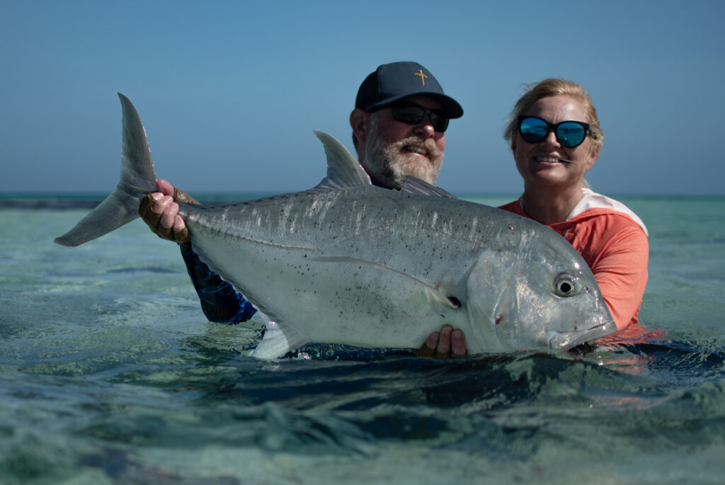 Two anglers showing off their good catch after joining us