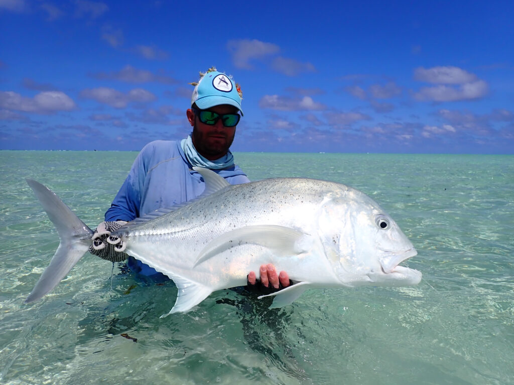Angler with his catch - monster giant trevally