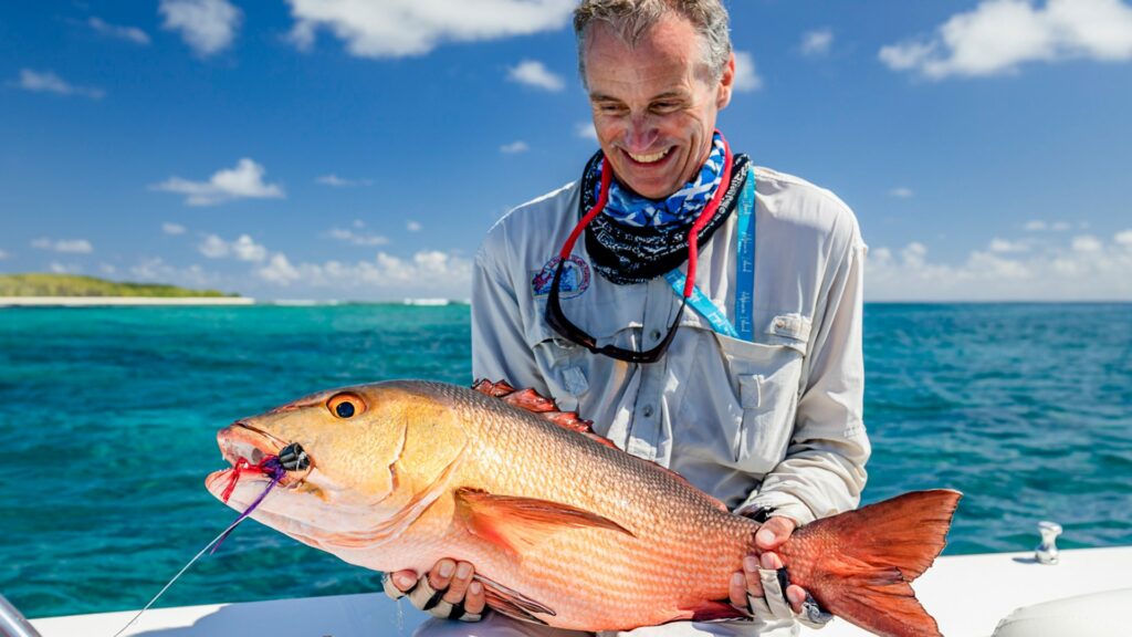 Angler with his catch at Colsmoledo Atoll