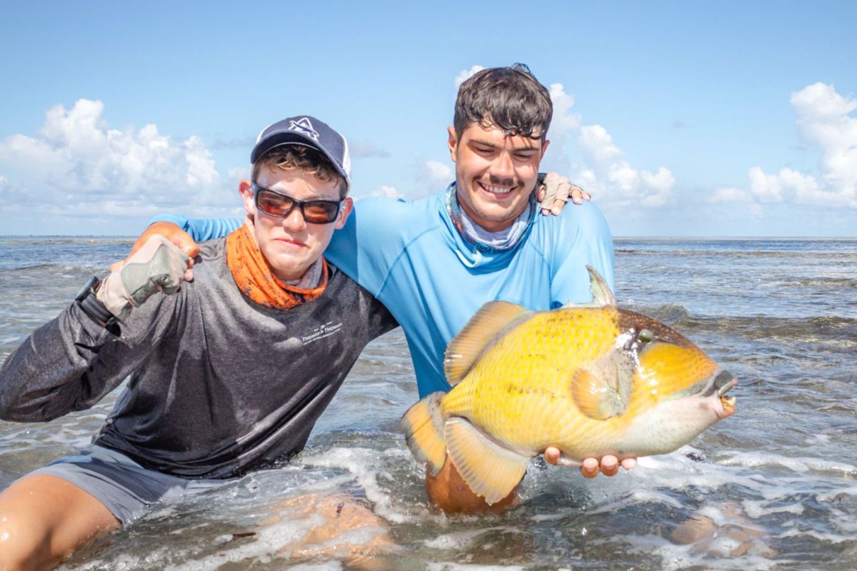 Two anglers showing off their whopping good atch