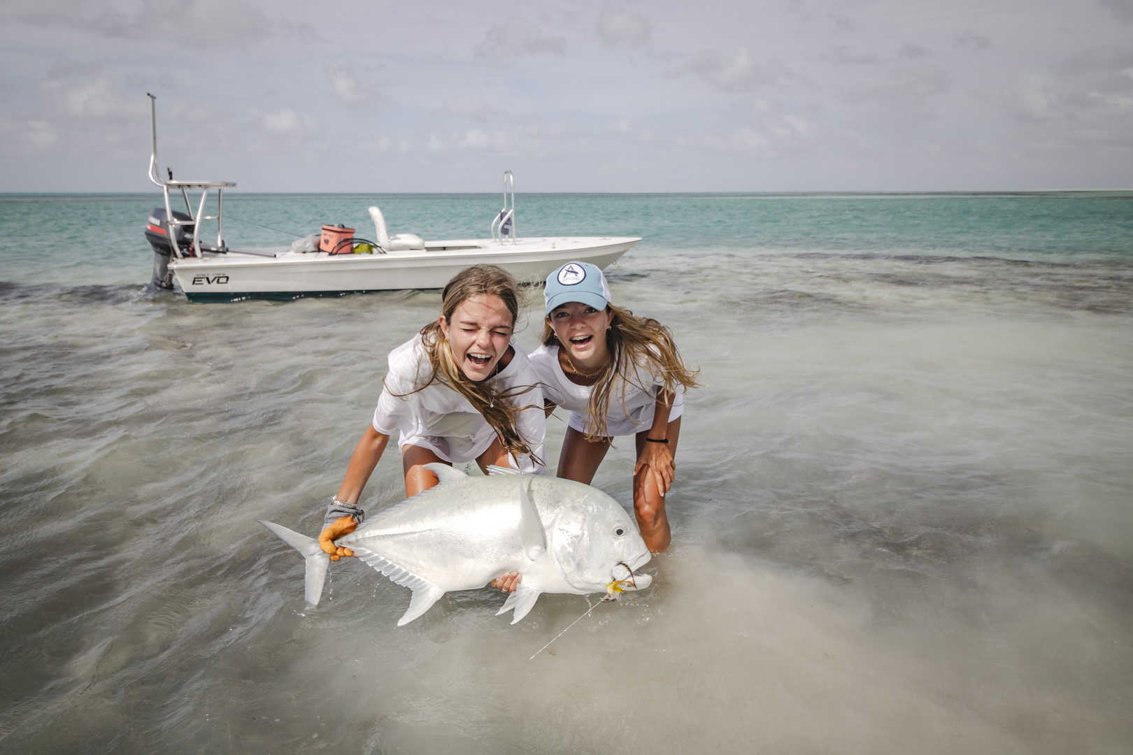 Young girls fly fishing