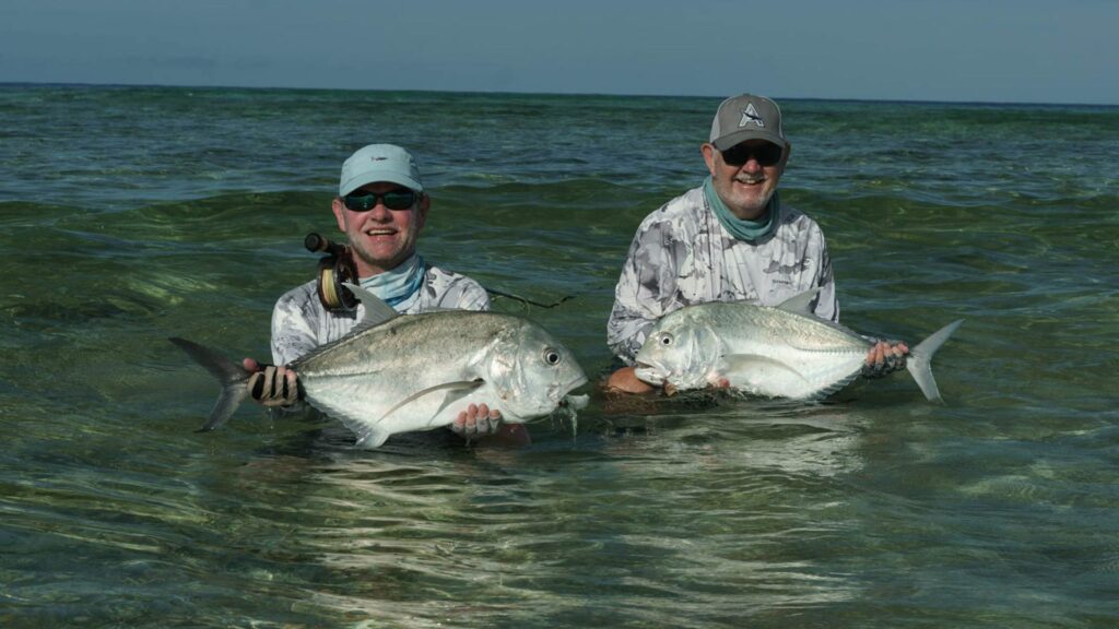 Two anglers in the water fly fishing