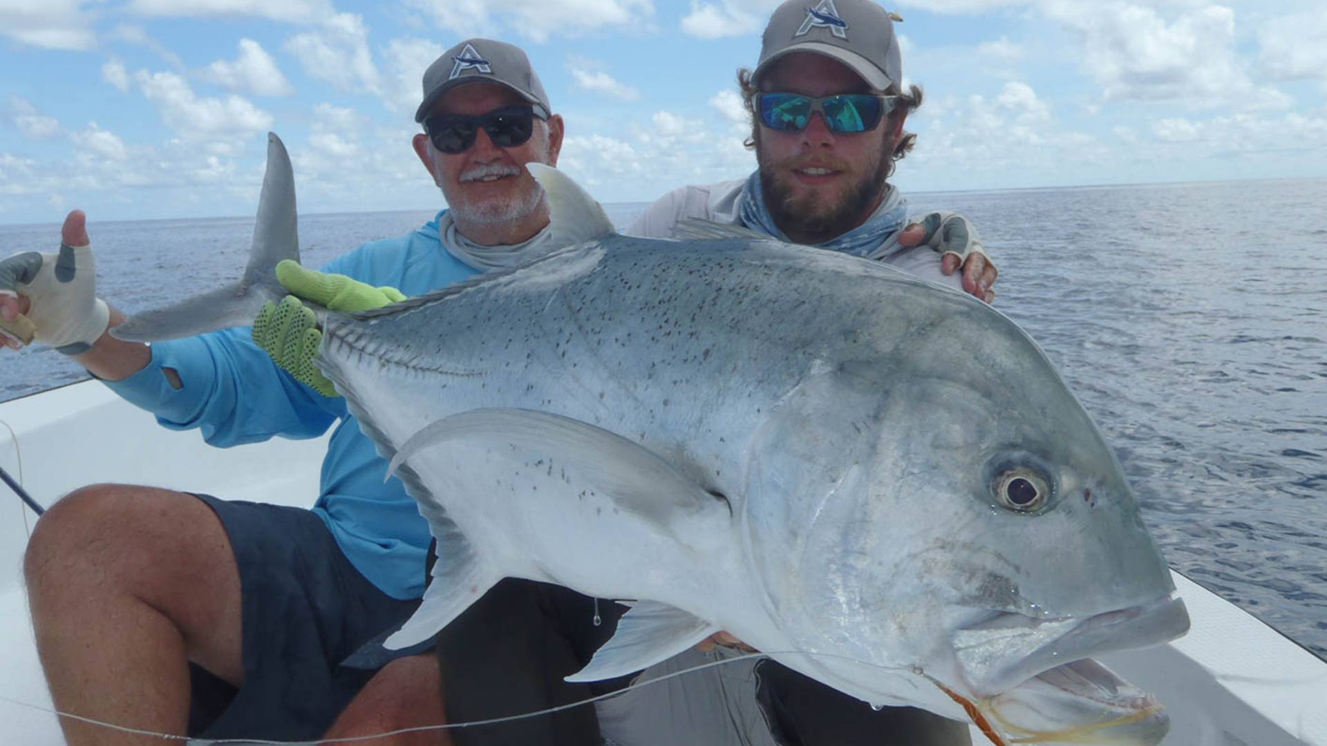 Two anglers holding a GT