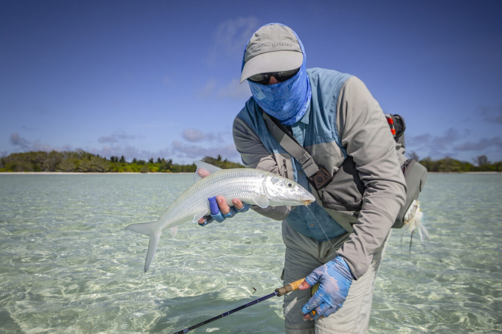 Fly fishing angler with his catch of a bonefish