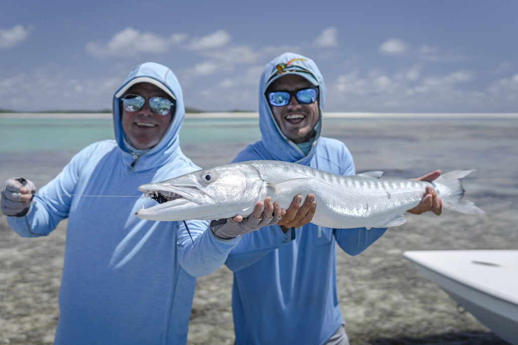 two fishermen with a barracuda