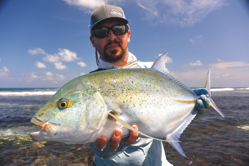 Liveaboard and fish- angler hold up his catch