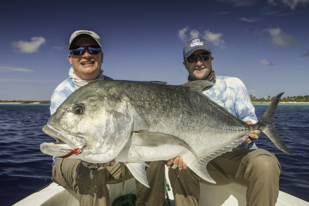Fly fishermen at wild Astove Atoll with a GT