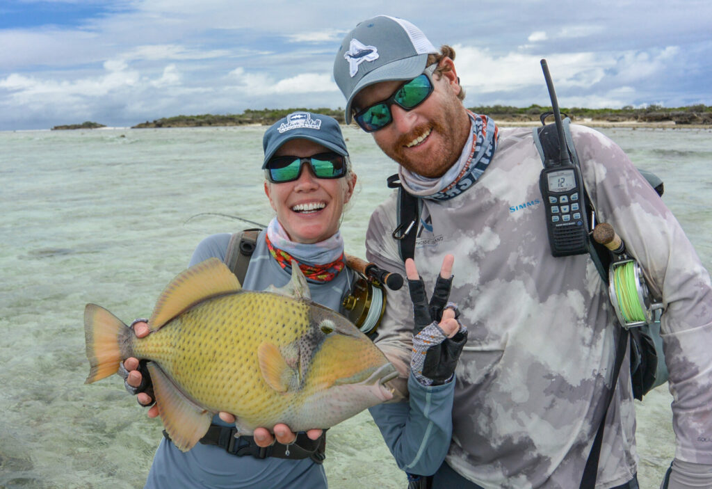 Pair of fly fishermen with a triggerfish