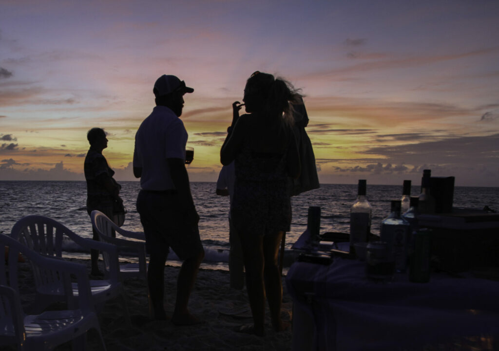 At wild Astove Atoll guests enjoying sunset