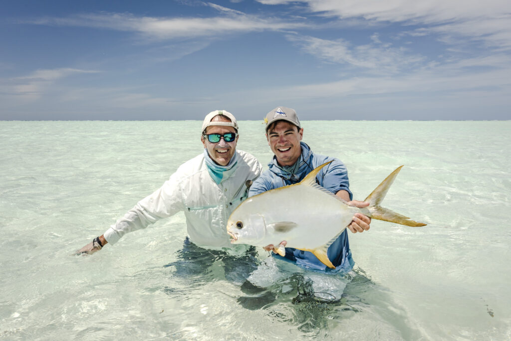 Fly fishing anglers holding a permit