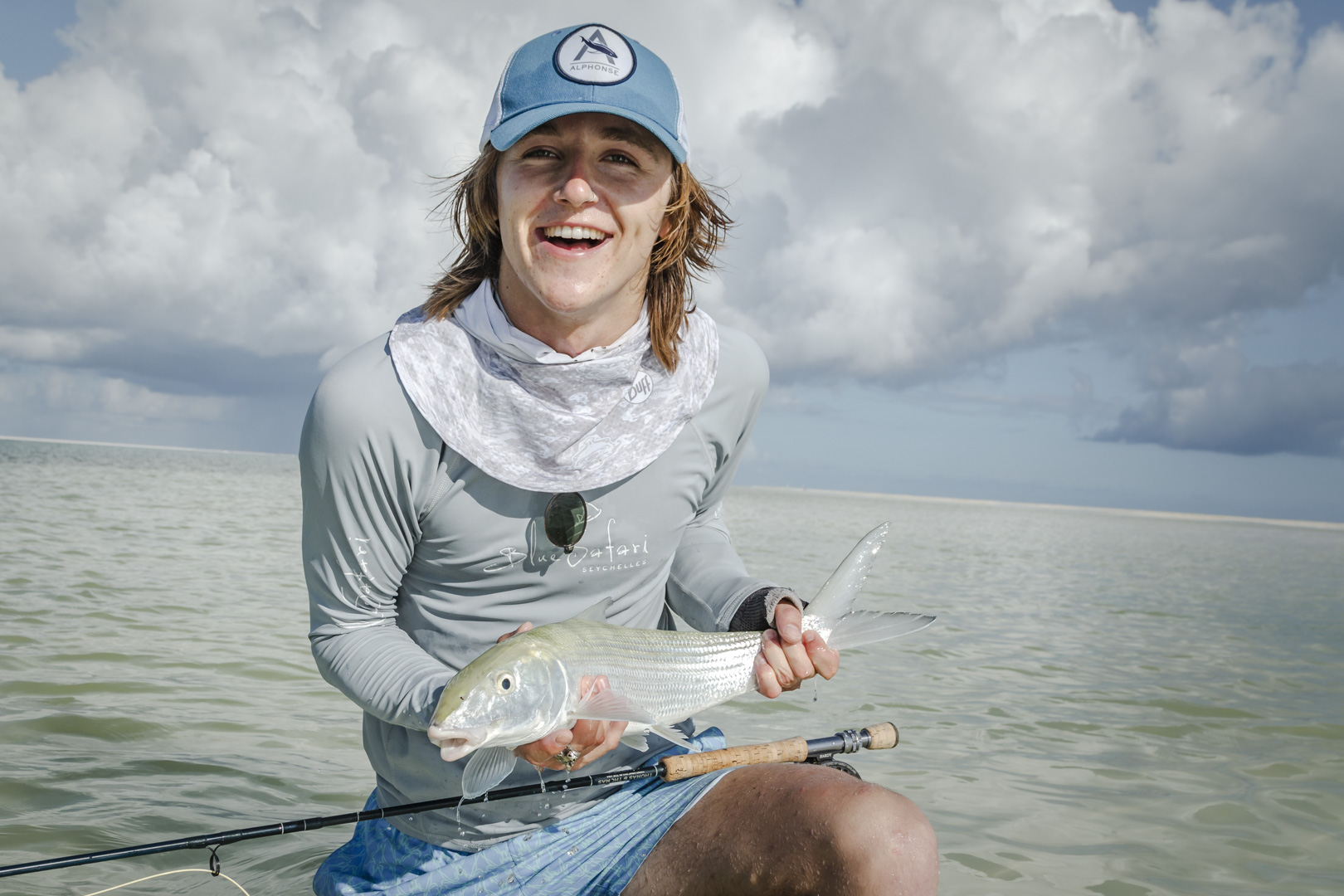 Young man holding a bonefish ch