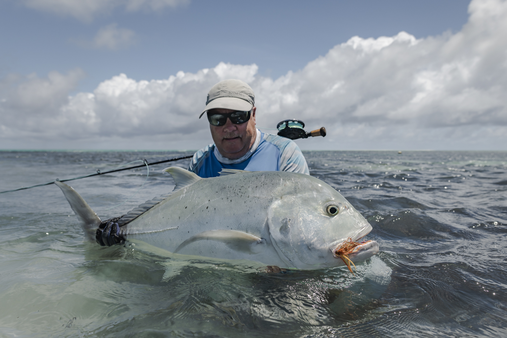 Angler with GT caught on fly
