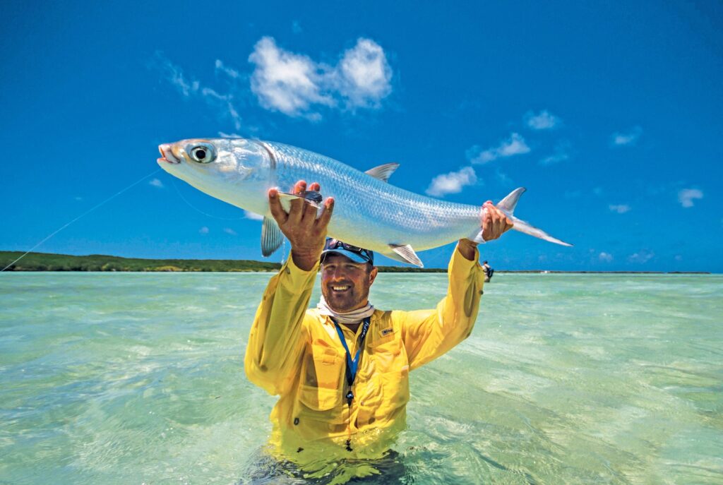 Angler with yellow jacket with a milkfish